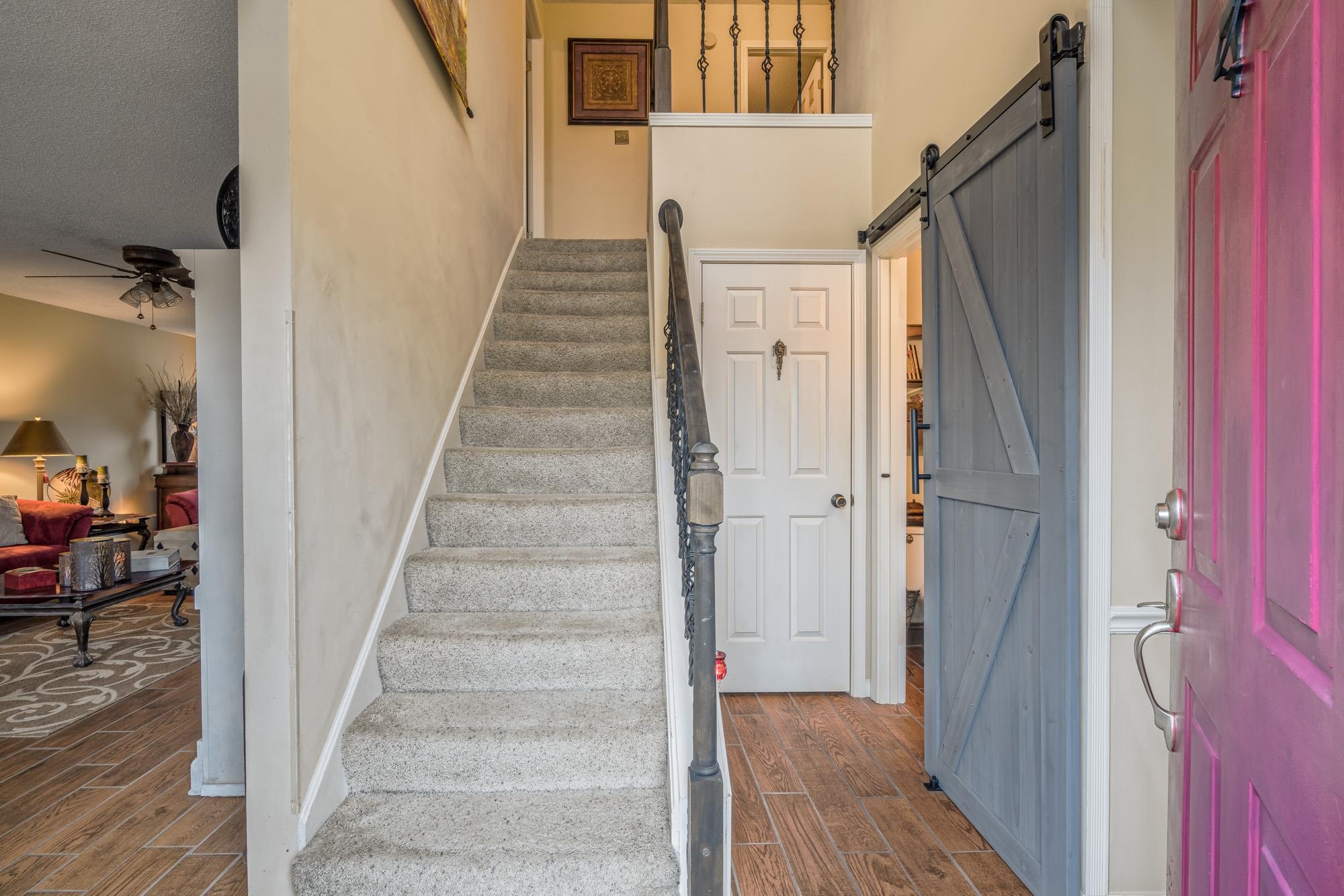 256 Windy Ridge Cove Collierville, TN 38017 - Photo 11 of 25 a view of a hallway with wooden floor and staircase