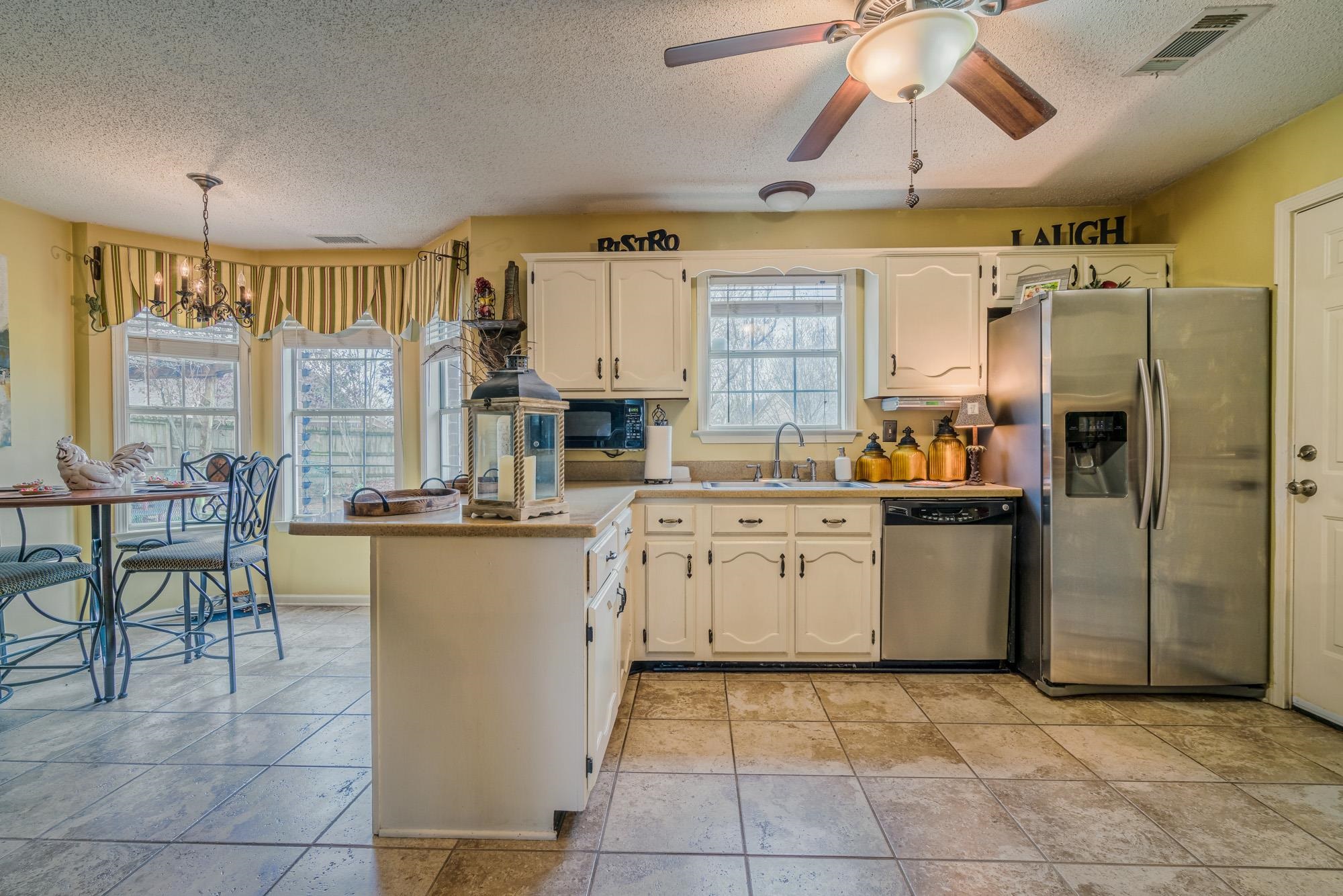 256 Windy Ridge Cove Collierville, TN 38017 - Photo 12 of 25 a kitchen with cabinets and chairs