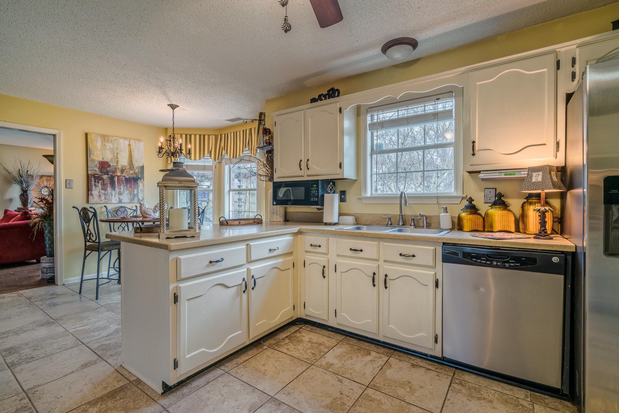 256 Windy Ridge Cove Collierville, TN 38017 - Photo 13 of 25 a kitchen with granite countertop cabinets a sink and a window