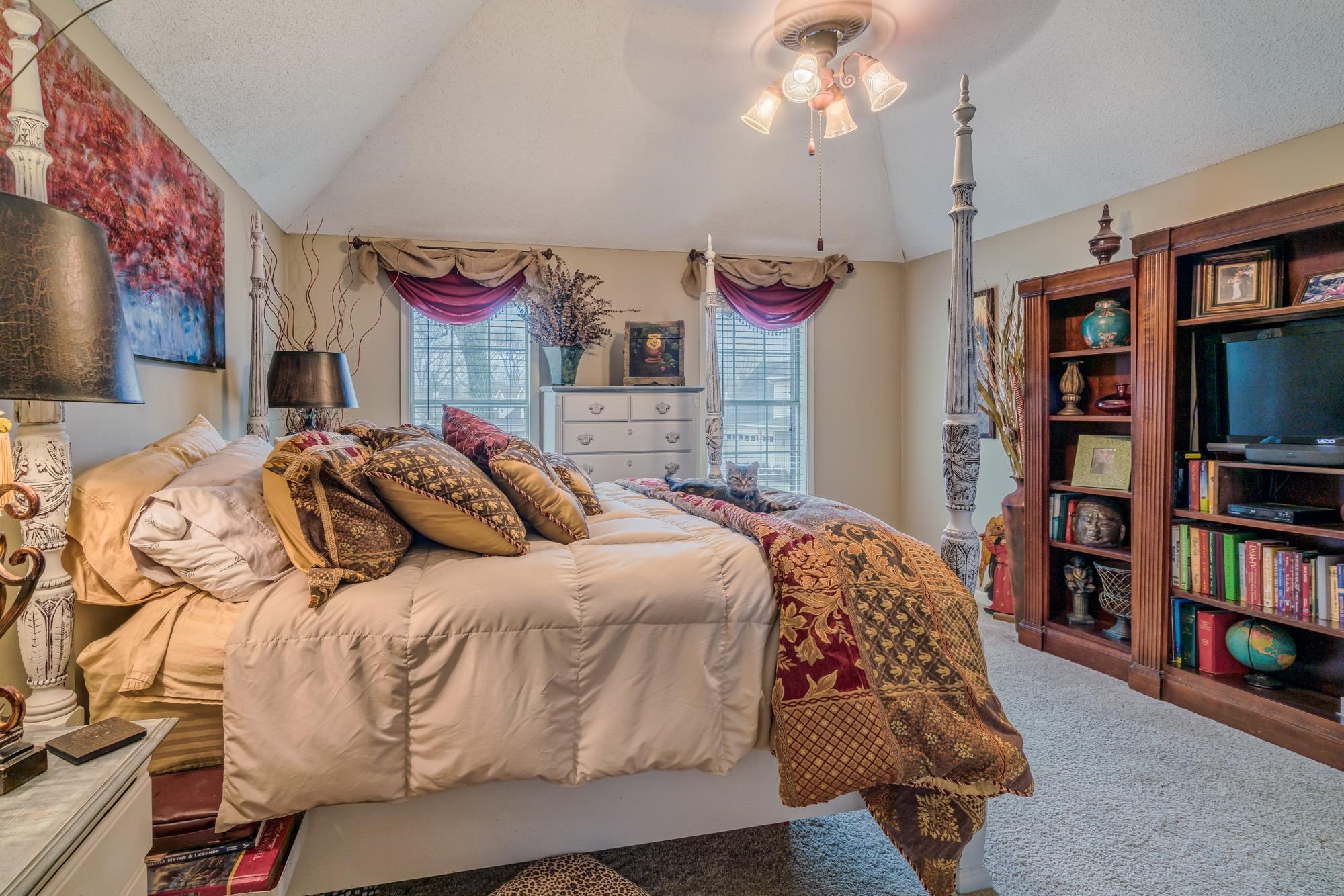 256 Windy Ridge Cove Collierville, TN 38017 - Photo 20 of 25 a bedroom with a bed and a bookshelf