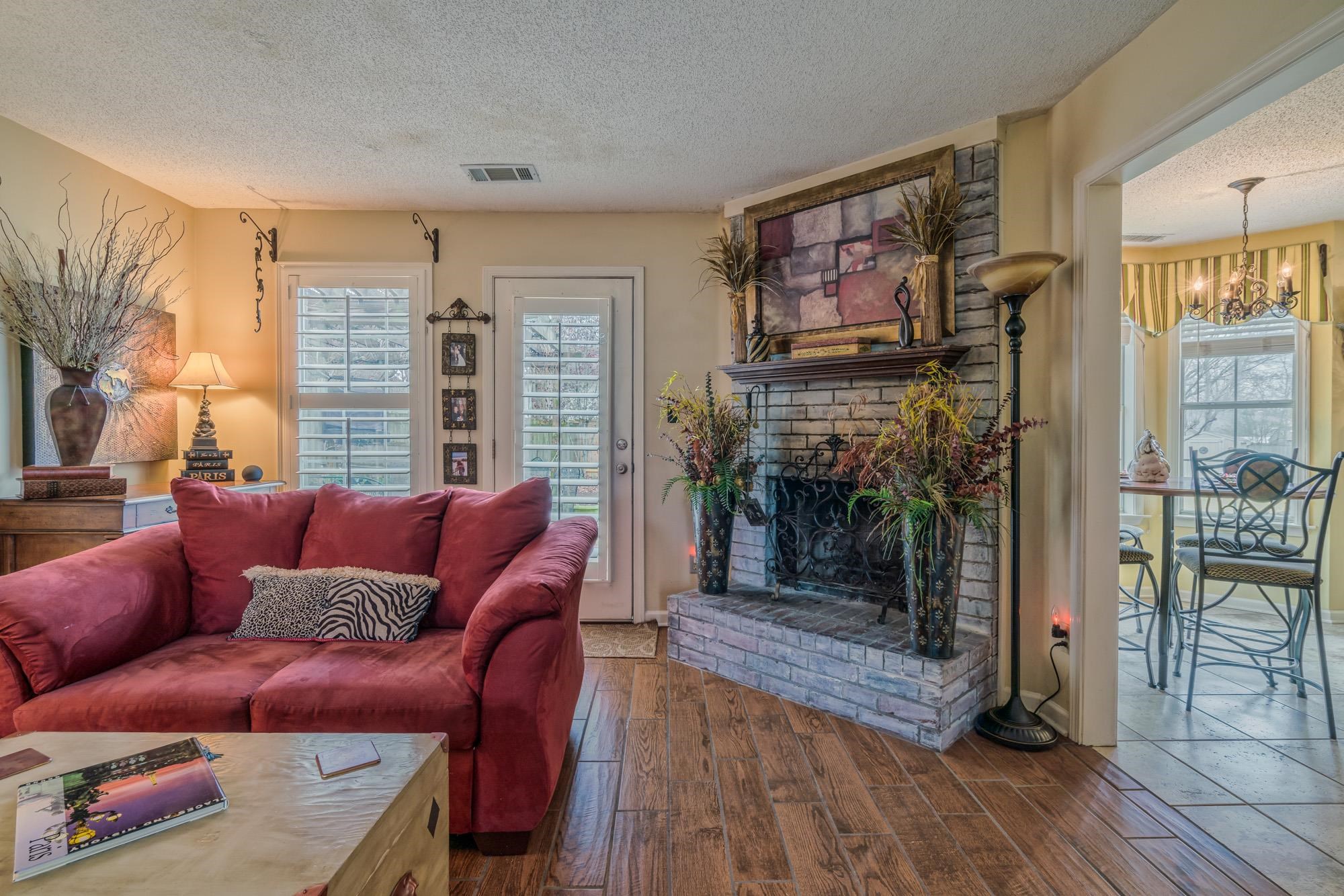 256 Windy Ridge Cove Collierville, TN 38017 - Photo 8 of 25 a living room with furniture a flat screen tv and a fireplace