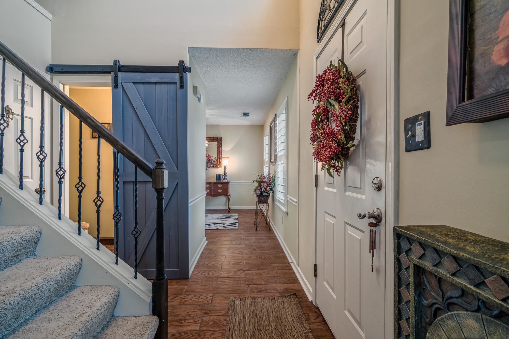 256 Windy Ridge Cove Collierville, TN 38017 - Photo 9 of 25 a view of a hallway with wooden floor and staircase