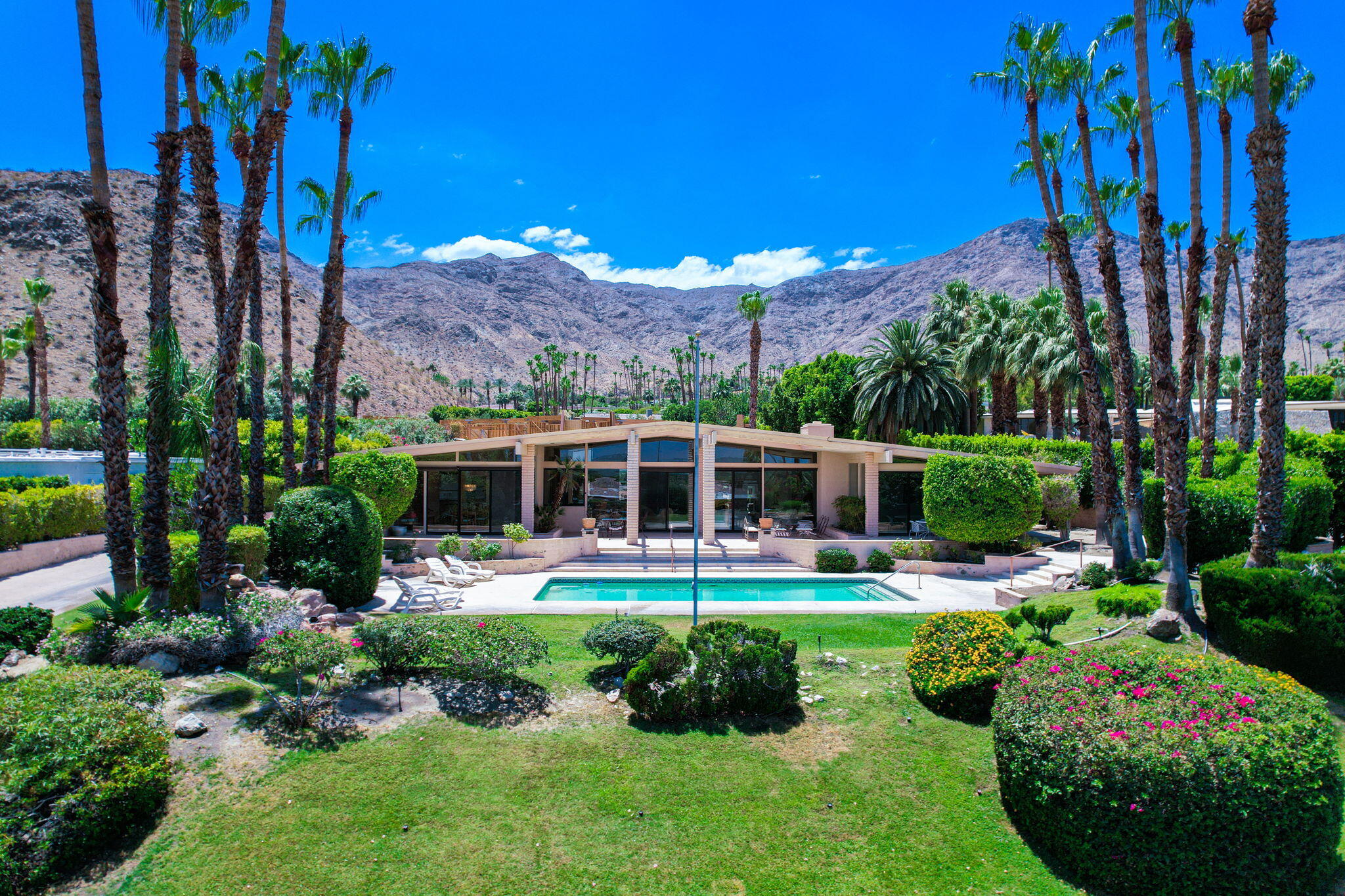 70465 Pecos Road Rancho Mirage, CA 92270 - Photo 2 of 48 a view of a house with a yard potted plants and large tree