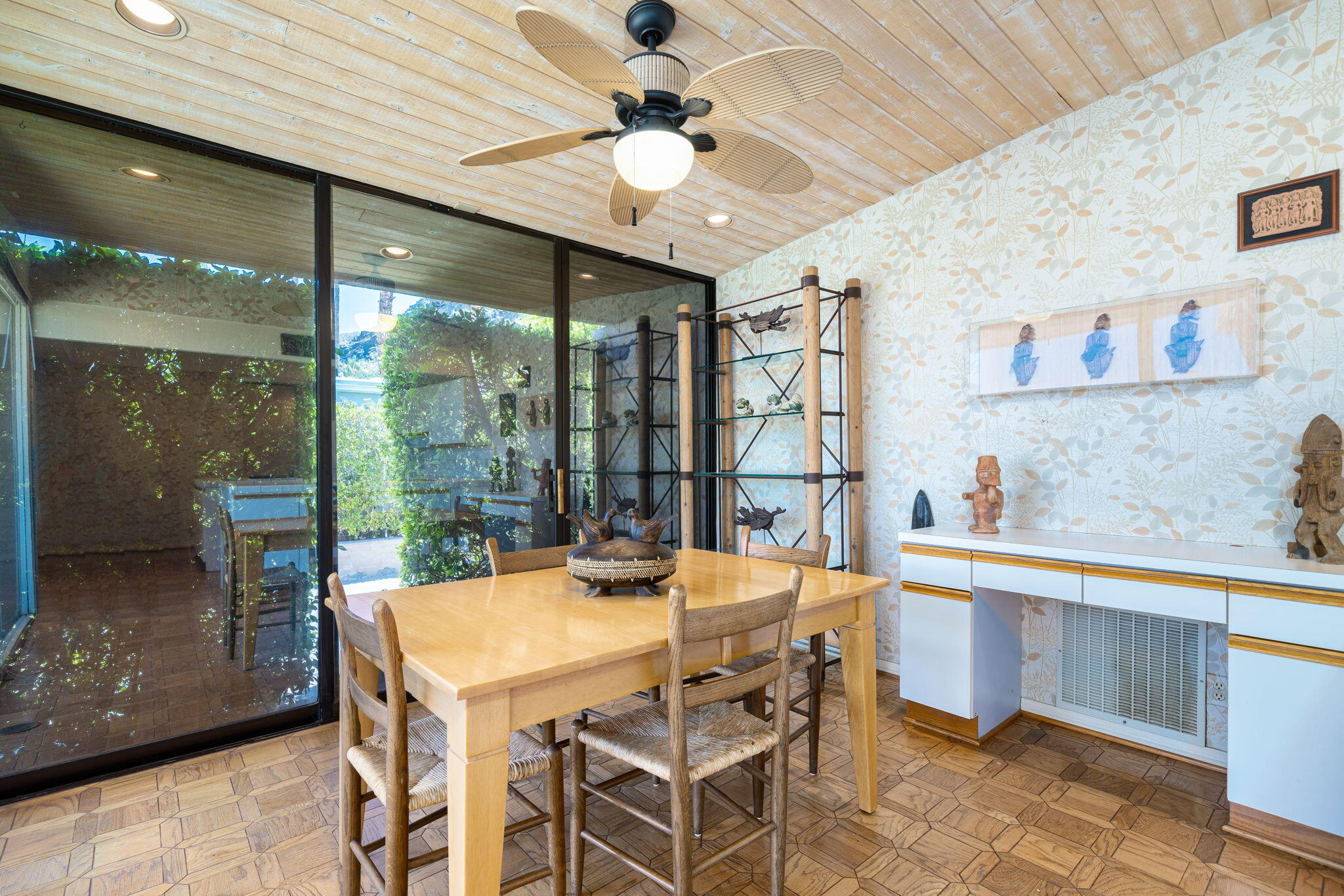 70465 Pecos Road Rancho Mirage, CA 92270 - Photo 24 of 48 a view of a dining room with furniture large windows and a chandelier