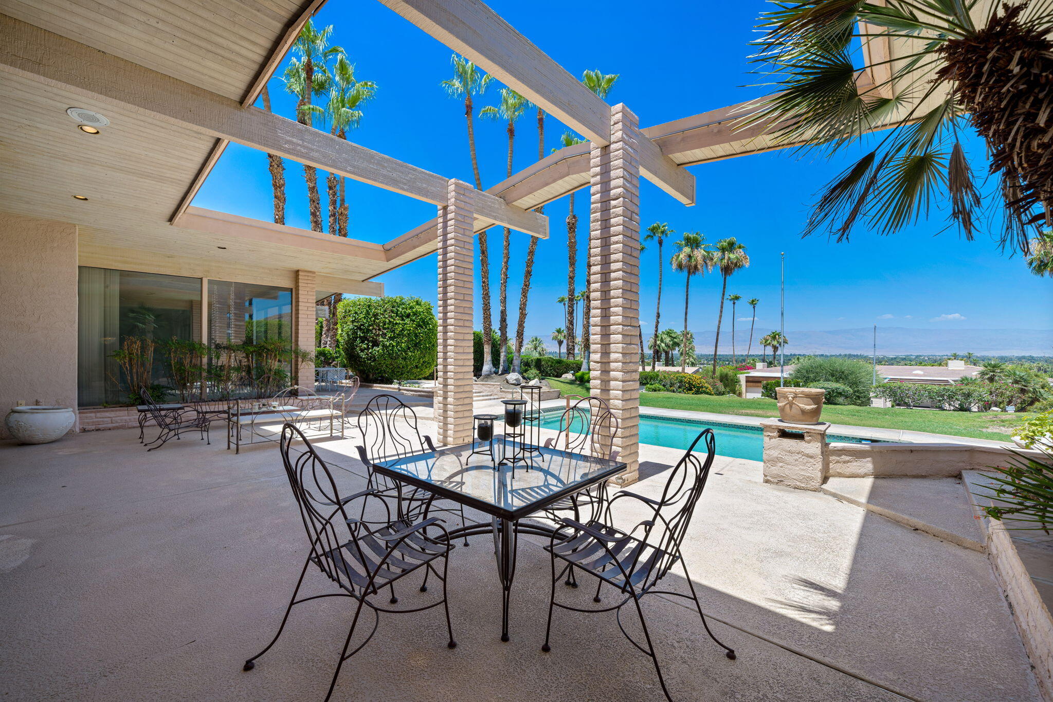 70465 Pecos Road Rancho Mirage, CA 92270 - Photo 34 of 48 a view of a patio with table and chairs and potted plants