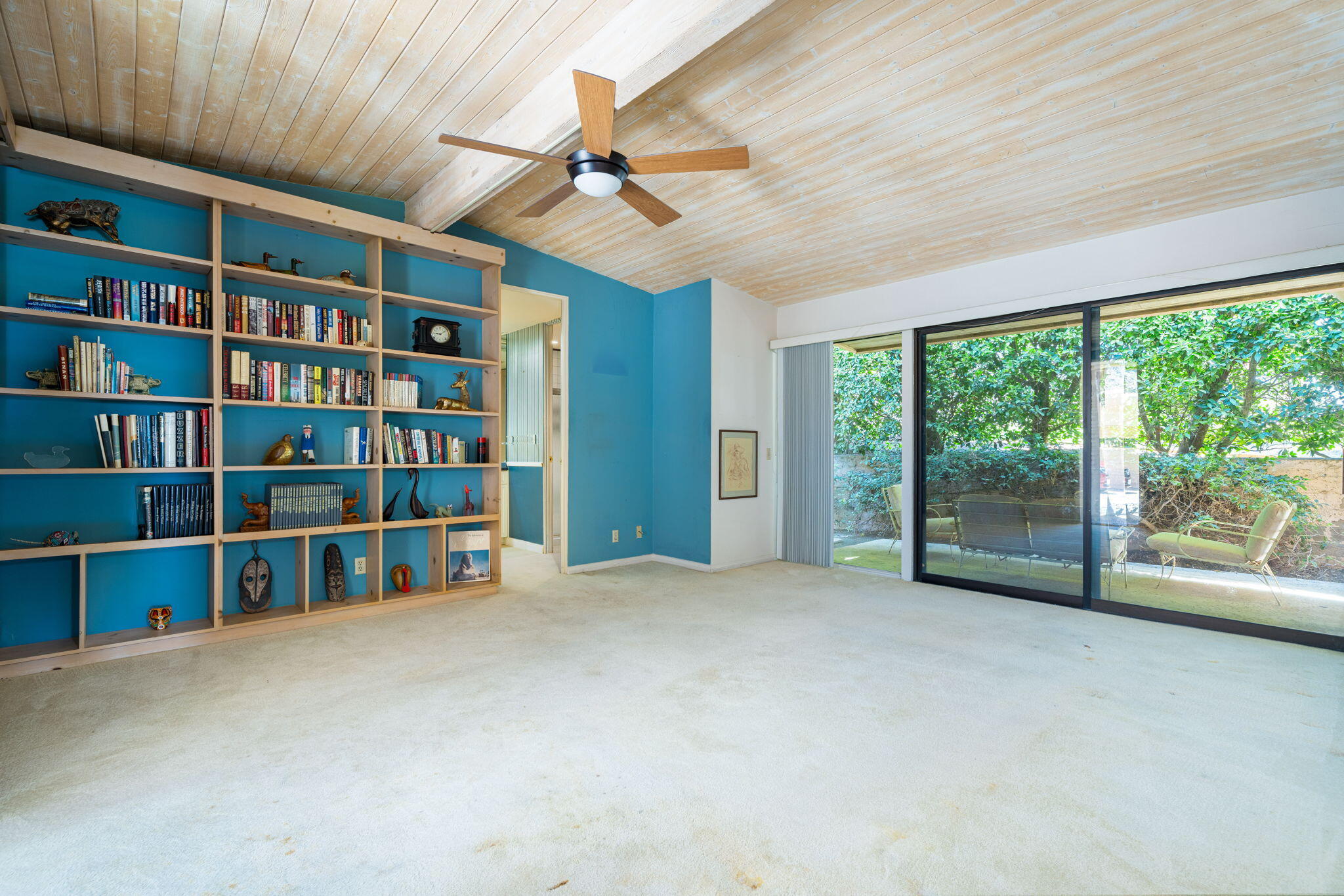 70465 Pecos Road Rancho Mirage, CA 92270 - Photo 42 of 48 a view of an empty room with a bookshelf and a large window