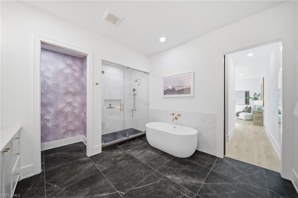 82 9th Street South, Unit 303 Naples, FL 34102 - Photo 11 of 26 a spacious bathroom with a sink and a mirror