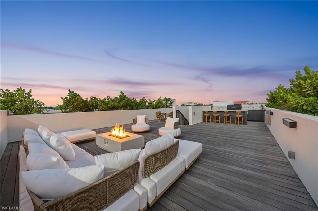 82 9th Street South, Unit 303 Naples, FL 34102 - Photo 24 of 26 PRIVATE roofdeck with firepit, and outdoor kitchen