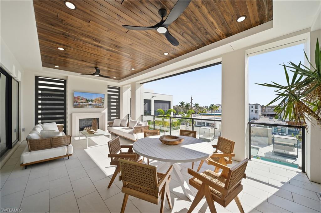 82 9th Street South, Unit 303 Naples, FL 34102 - Photo 8 of 26 a view of a dining room with furniture window and outside view