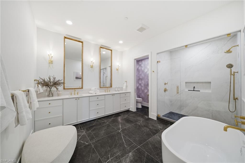 82 9th Street South, Unit 303 Naples, FL 34102 - Photo 10 of 26 a bathroom with a double vanity sink toilet and shower