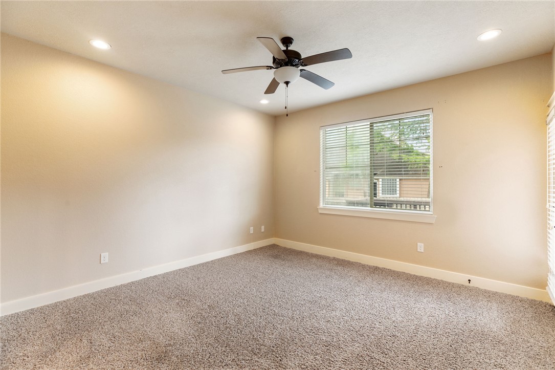 2136 Rockcliffe Loop College Station, TX 77845 - Photo 27 of 48 an empty room with ceiling fan and windows