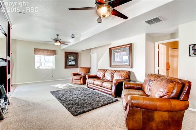 9425 Winged Foot Road Peyton, CO 80831 - Photo 18 of 28 Built in entertainment center, surround sound and two heated fans.