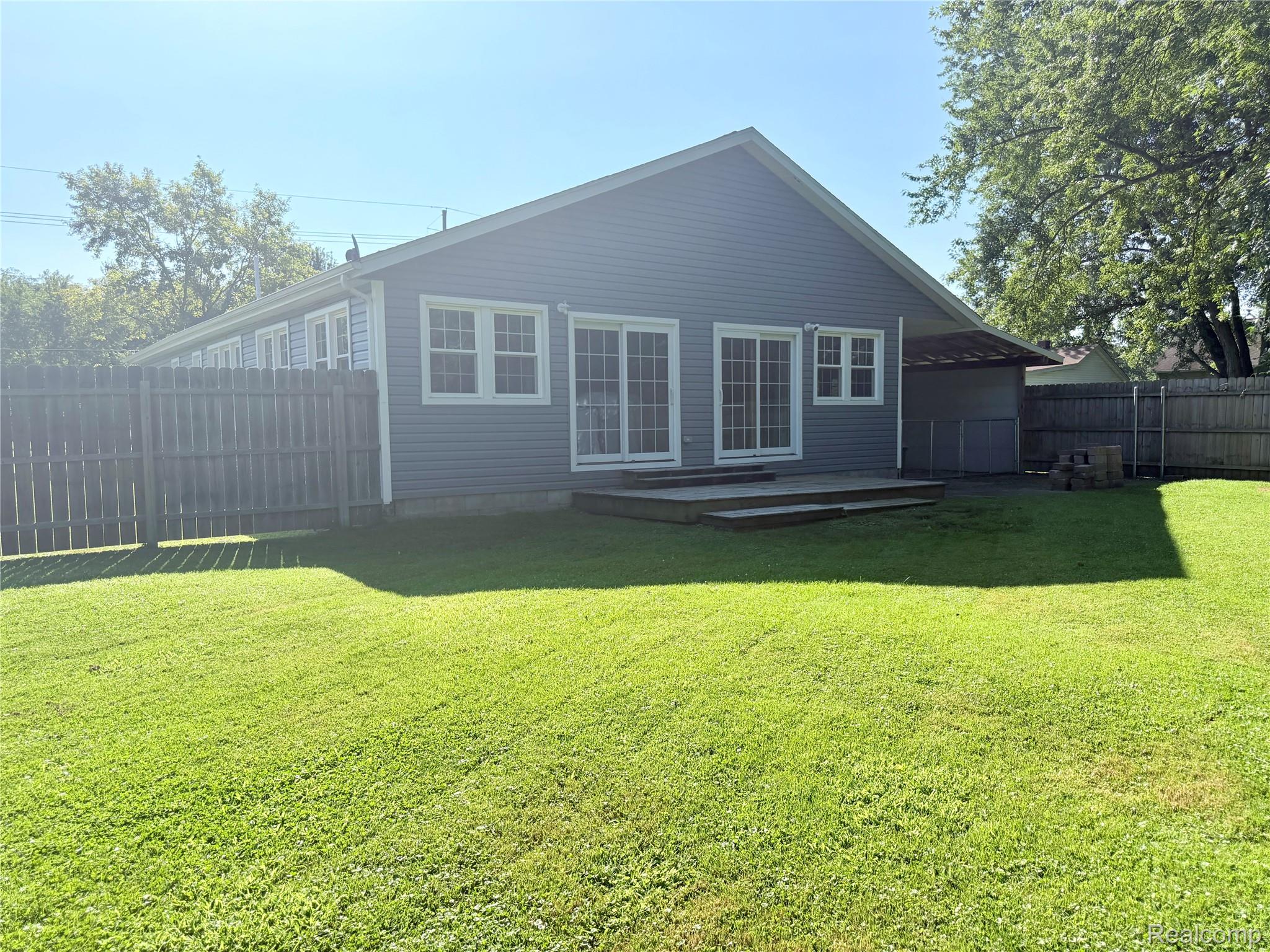 1295 Allen Road Smiths Creek, MI 48074 - Photo 26 of 28 Rear exterior with blue siding and white trim windows