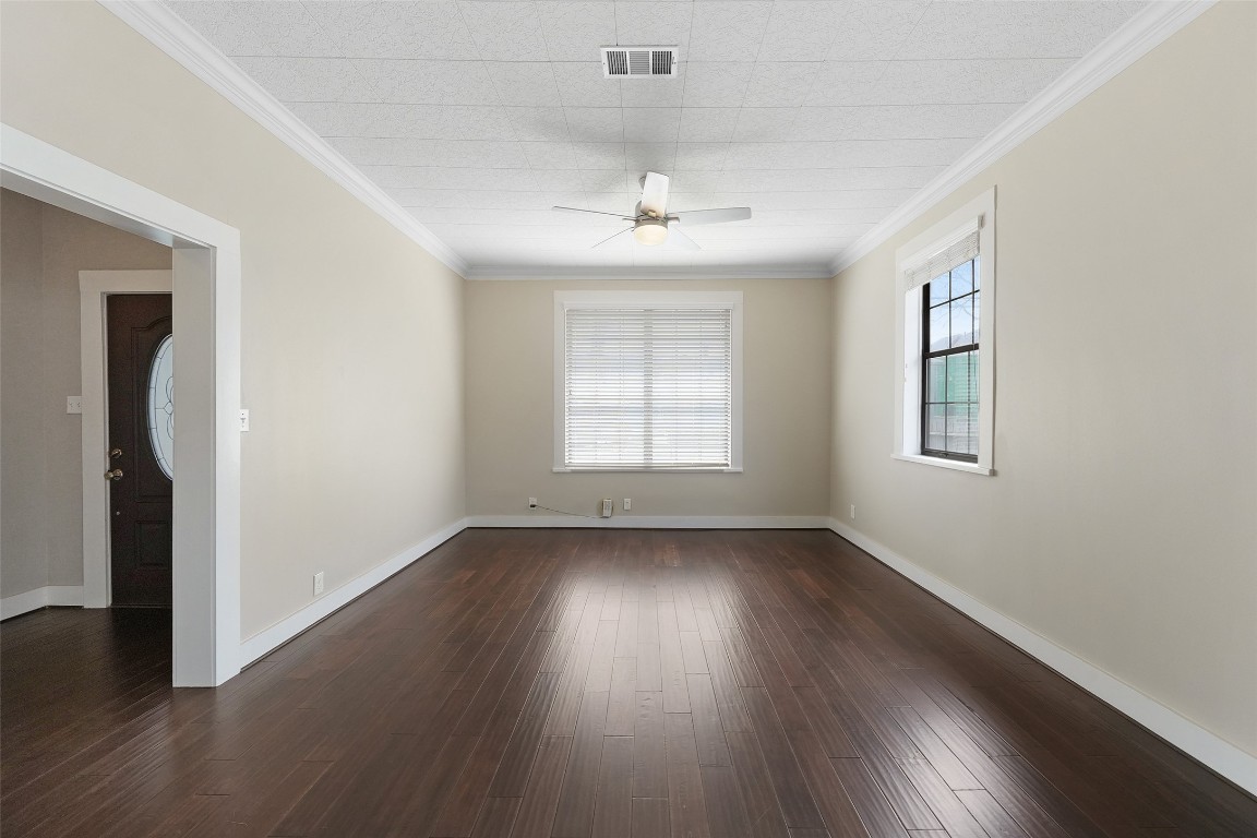 309 Pecore Street Houston, TX 77009 - Photo 11 of 45 an empty room with wooden floor chandelier and windows