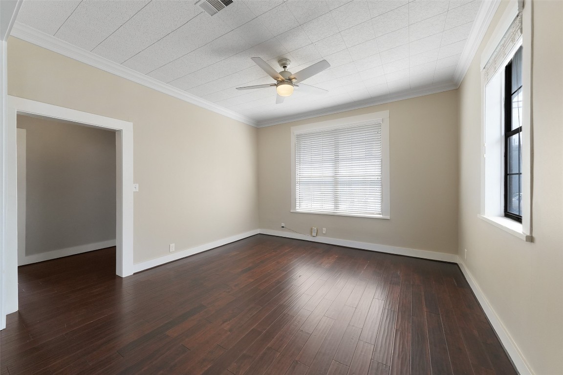 309 Pecore Street Houston, TX 77009 - Photo 12 of 45 a view of an empty room with wooden floor and a window