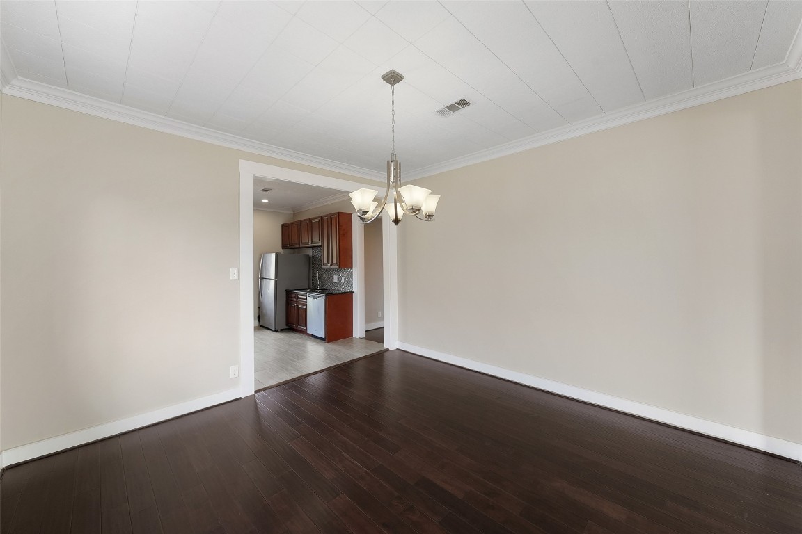 309 Pecore Street Houston, TX 77009 - Photo 13 of 45 a view of a room with wooden floor chandelier and closet