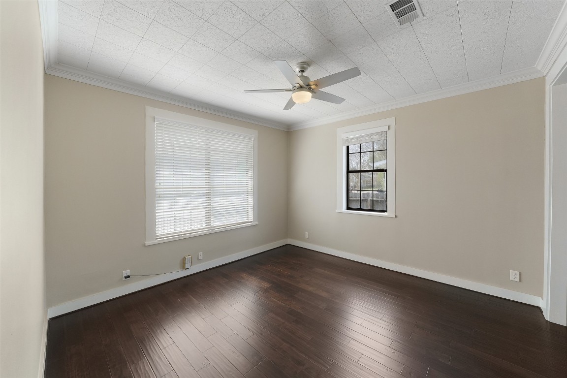 309 Pecore Street Houston, TX 77009 - Photo 15 of 45 an empty room with wooden floor ceiling fan and windows