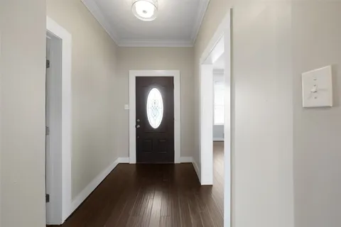 a view of a hallway with wooden floor