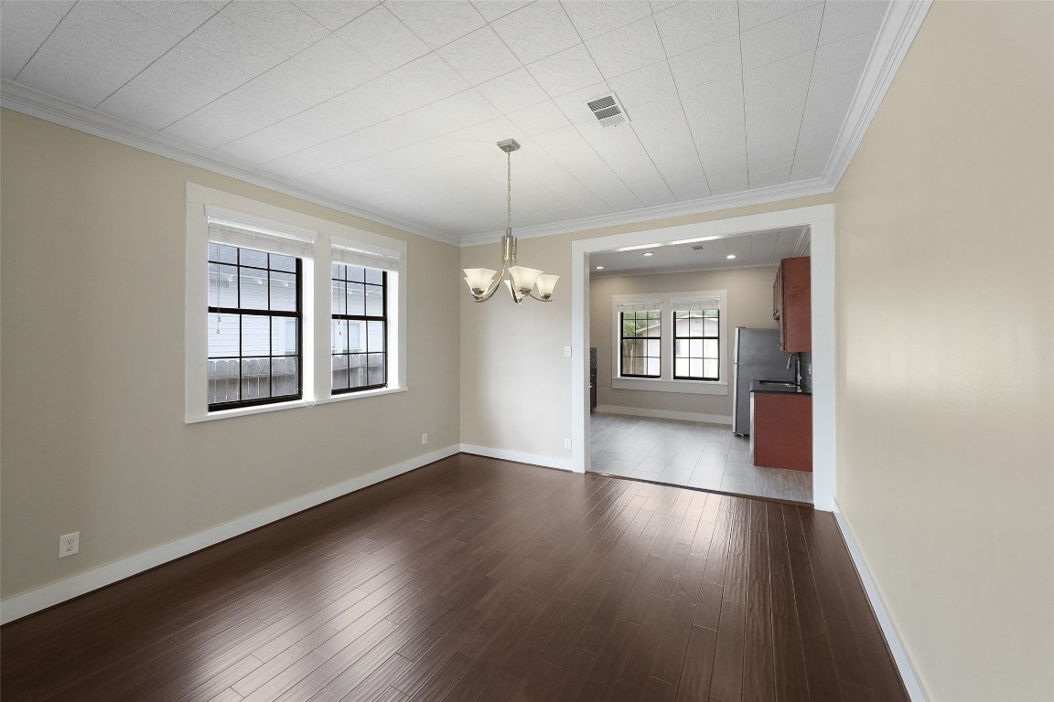 309 Pecore Street Houston, TX 77009 - Photo 19 of 45 an empty room with wooden floor and windows