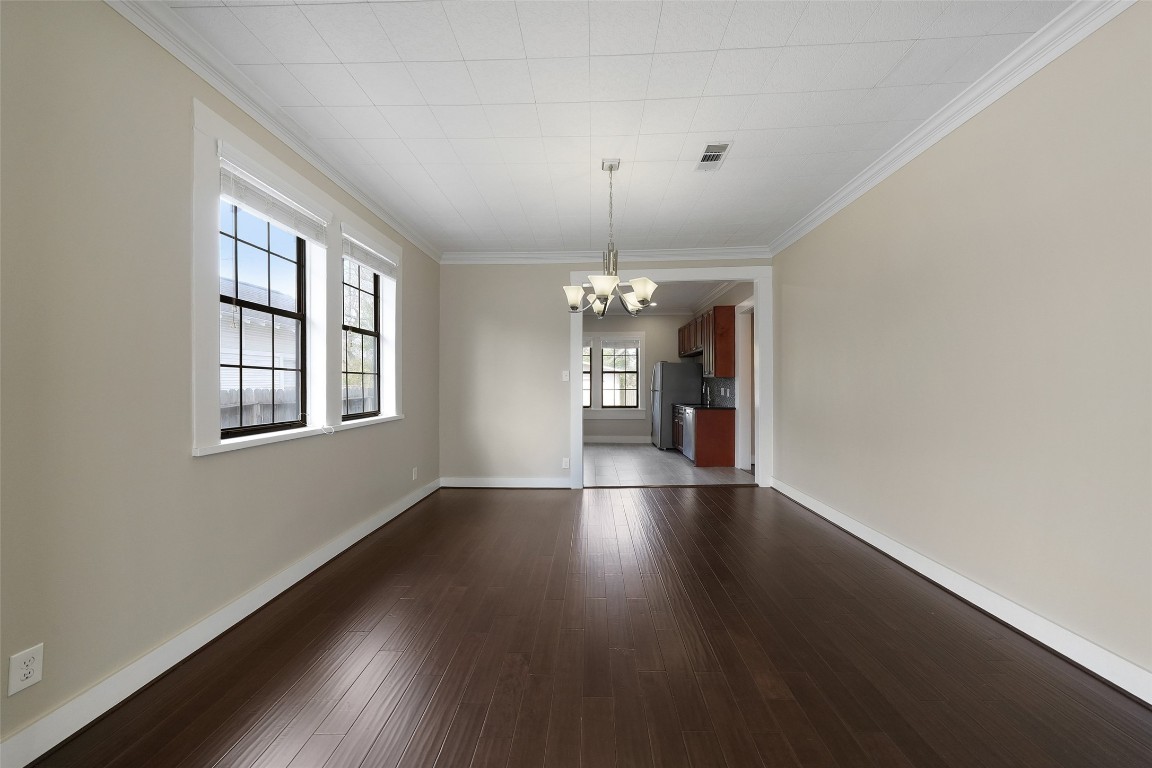309 Pecore Street Houston, TX 77009 - Photo 20 of 45 a view of an empty room with wooden floor and a window
