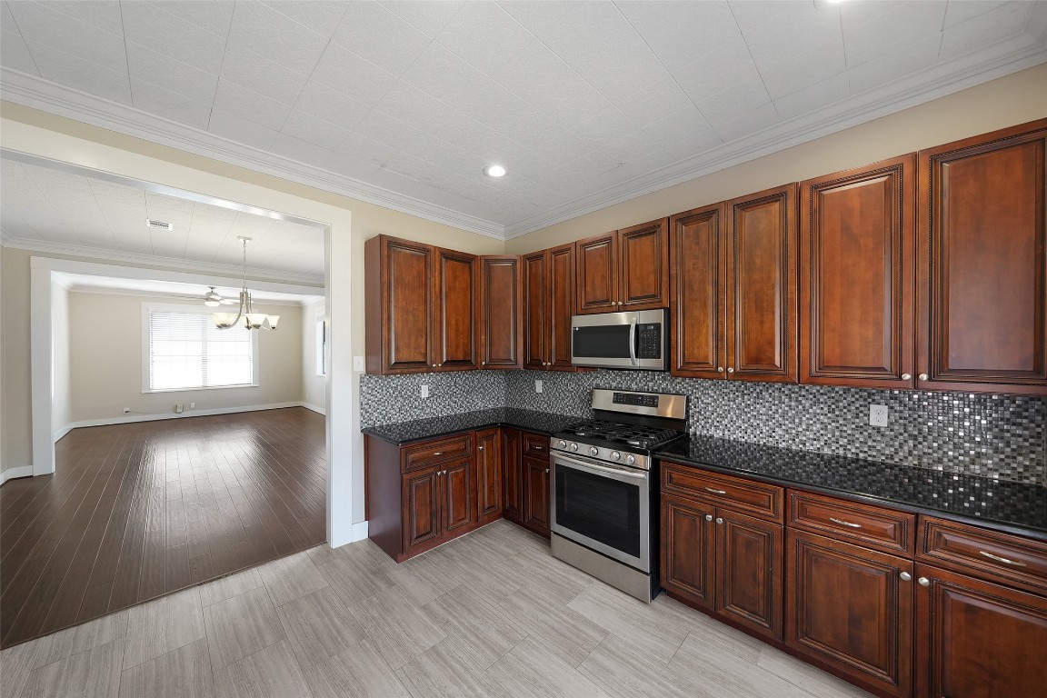 309 Pecore Street Houston, TX 77009 - Photo 25 of 45 a kitchen with stainless steel appliances granite countertop a sink stove and refrigerator