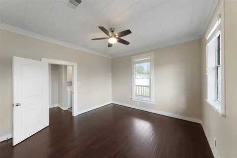a view of a livingroom with wooden floor and a window