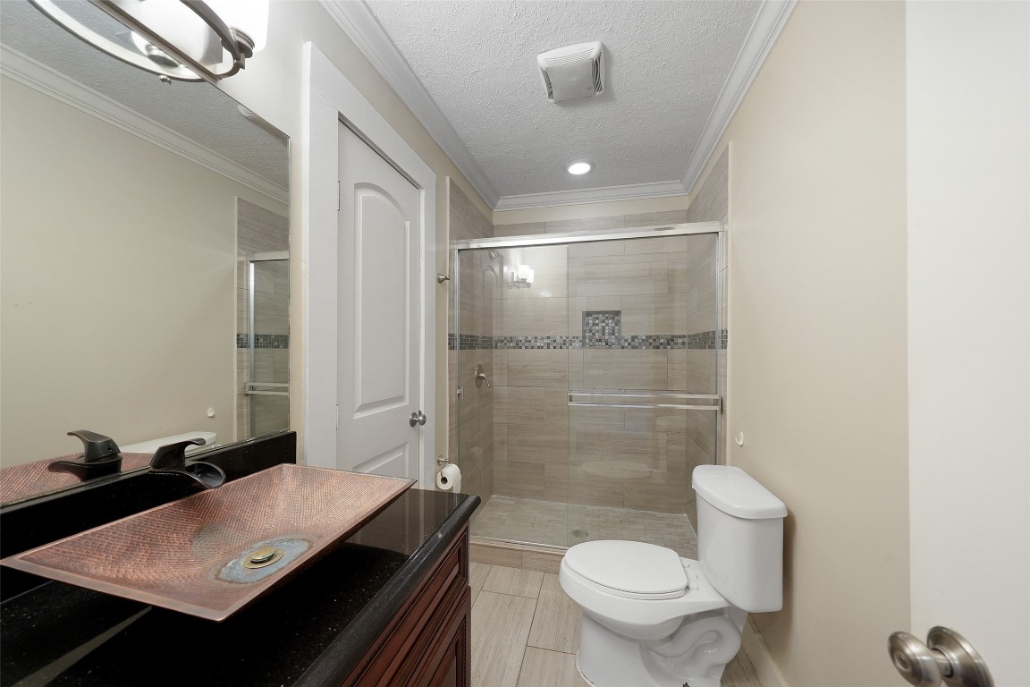 309 Pecore Street Houston, TX 77009 - Photo 30 of 45 a bathroom with a sink a toilet a mirror and shower