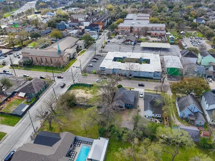 an aerial view of residential houses with outdoor space