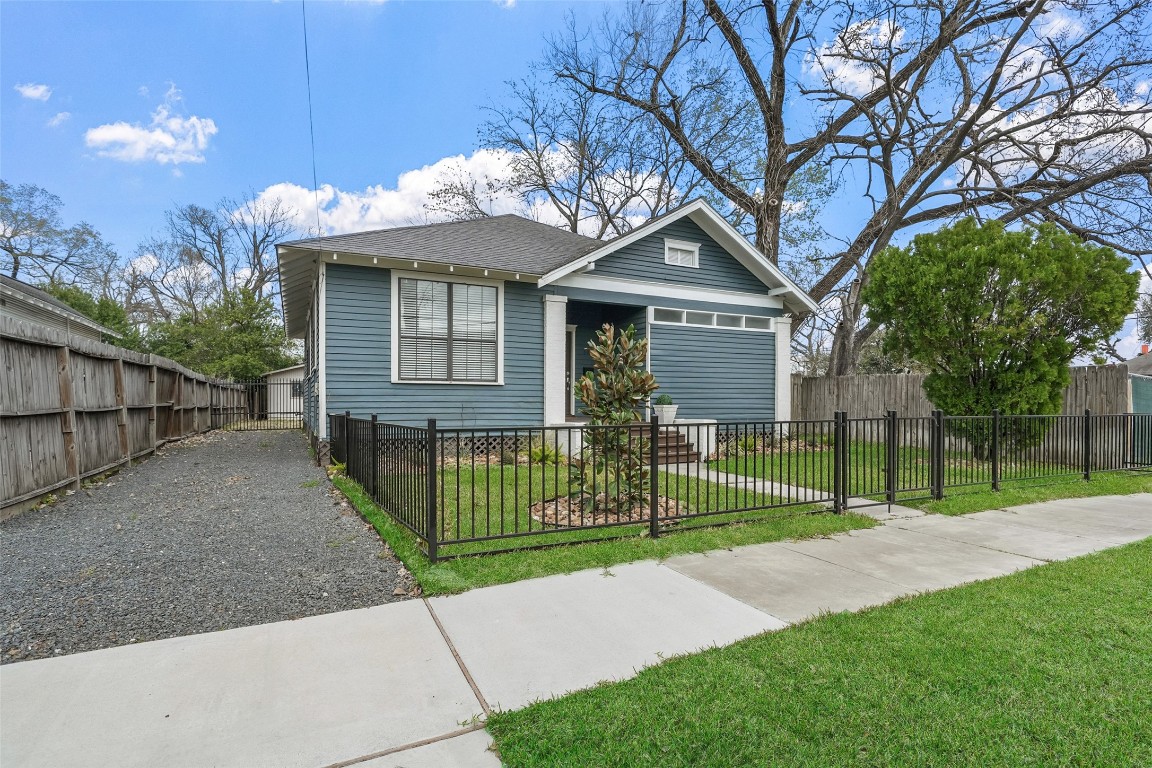 309 Pecore Street Houston, TX 77009 - Photo 5 of 45 a view of a house with a small yard and a large tree