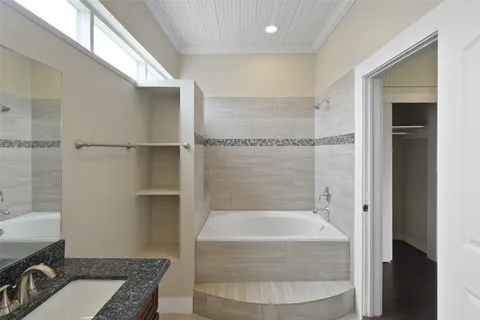 a bathroom with a tub shower sink and a toilet