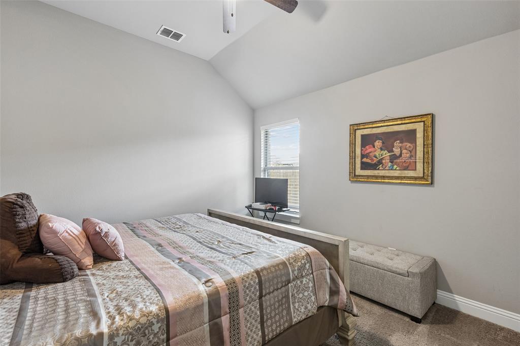 108 Maverick Lane Pilot Point, TX 76258 - Photo 22 of 27 Vaulted ceiling room featuring neutral wall paint, carpet flooring, a single window, and a ceiling fan