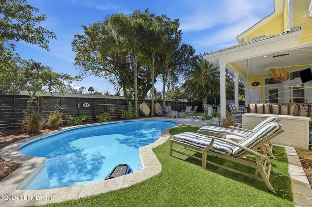 a view of a patio with dining table and chairs with a barbeque grill and couches
