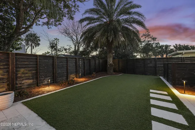 a view of a hallway with furniture and wooden floor