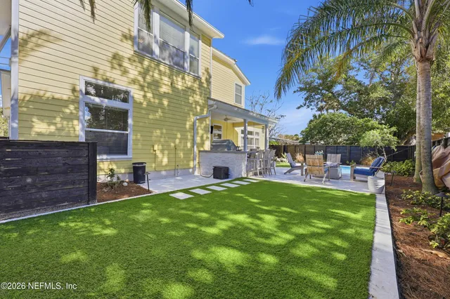 a dining room with furniture entryway and wooden floor