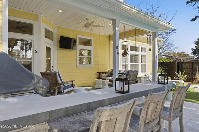 a open kitchen with stainless steel appliances kitchen island granite countertop a stove a refrigerator a oven a dining table and chairs with wooden floor