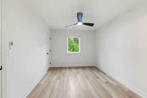a view of room with window and ceiling fan