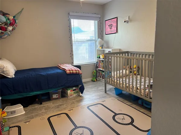 a bedroom with furniture and a window