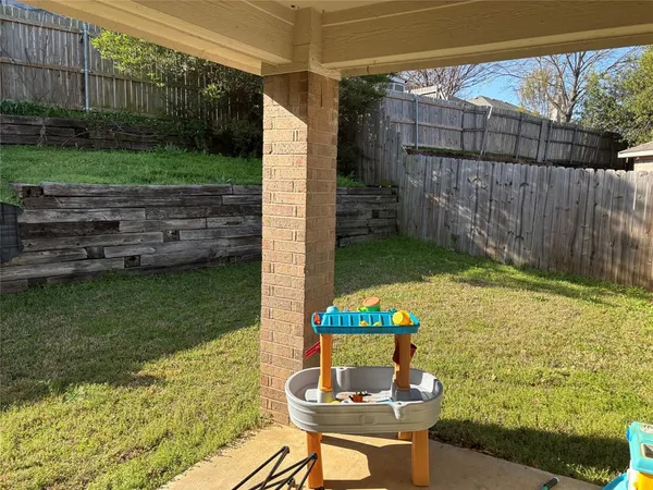 a backyard of a house with outdoor seating