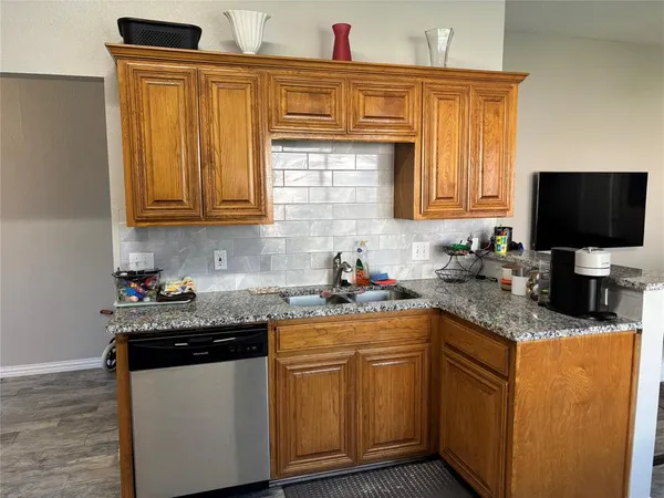 a kitchen with stainless steel appliances granite countertop a sink stove and microwave