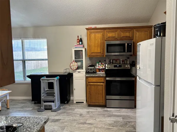 a kitchen with a refrigerator stove and sink