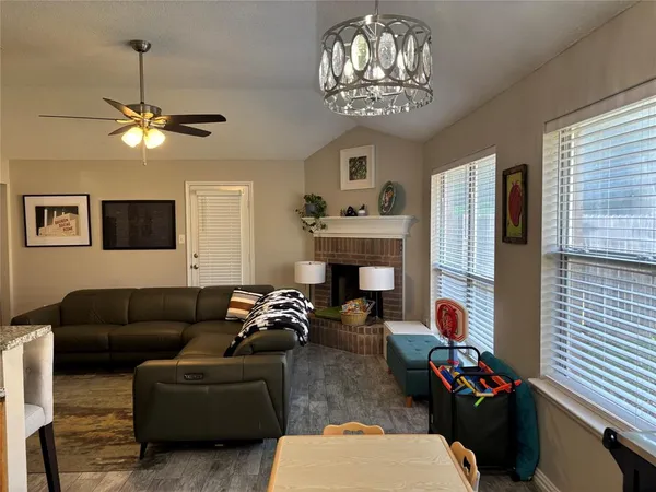 a living room with furniture a fireplace and a window