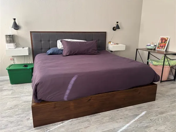 a bedroom with a bed and a chair