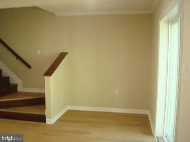 a view of a room with wooden floor