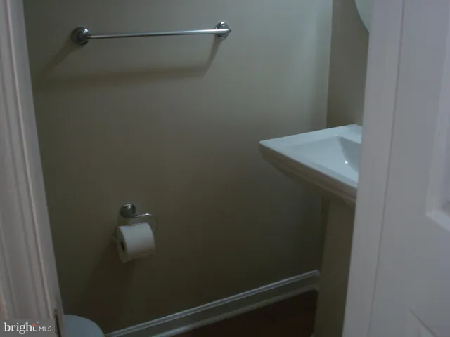 a view of a small space with wooden floor and fan