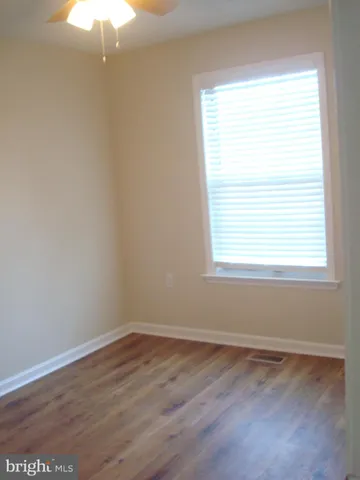 a bathroom with a sink a toilet a mirror and bathtub