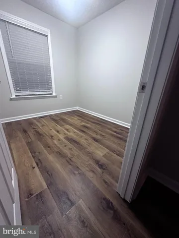 a spacious bathroom with a double vanity sink a large mirror and shower