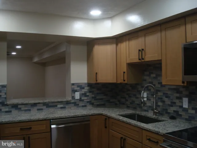 a kitchen with a sink and cabinets