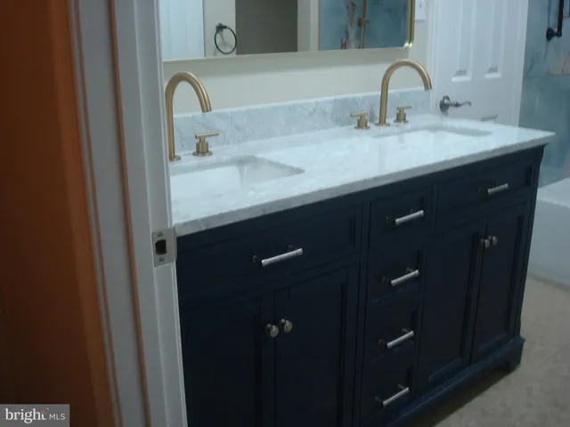 a bathroom with a sink and mirror