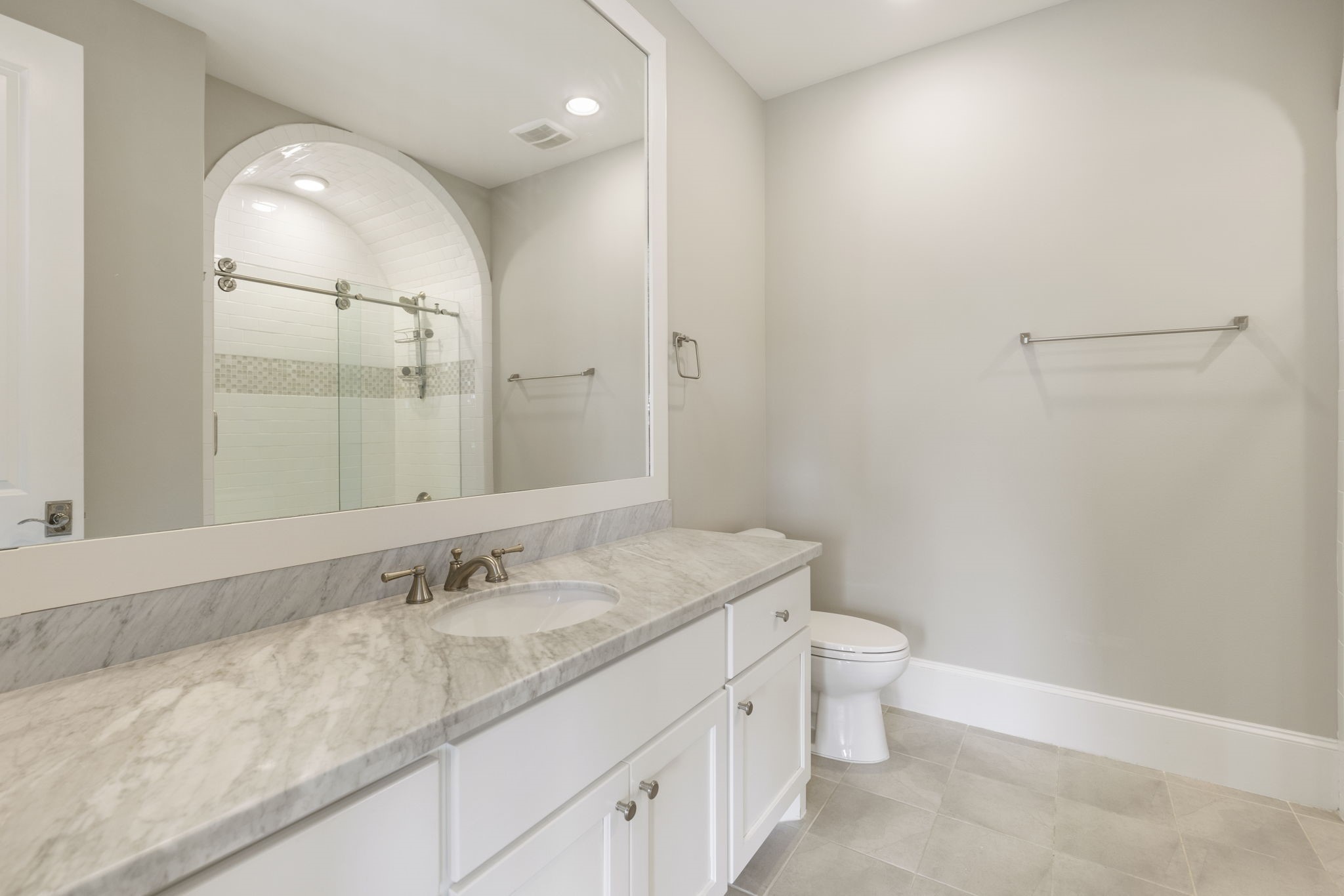 6806 West Warwick Lake Lane Spring, TX 77389 - Photo 39 of 50 a bathroom with a granite countertop sink a toilet and a mirror