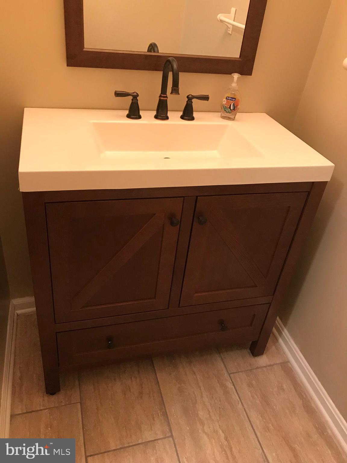 1458 Riverside Avenue, Unit 2B Baltimore, MD 21230 - Photo 12 of 16 a bathroom with a sink and a mirror